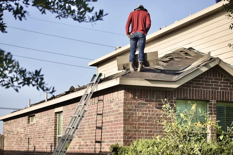 Professional roofer working on a residential roof in Hamilton Place